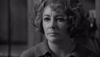 Movie still from “Who's Afraid of Virginia Woolf?” (1966), directed by Mike Nichols – Black and white photograph of a woman with curly hair; Close Up shot, Over the shoulder angle