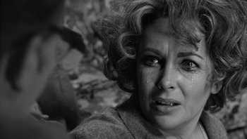 Movie still from “Who's Afraid of Virginia Woolf?” (1966), directed by Mike Nichols – A person with a tear in her eye; Close Up shot, Over the shoulder angle