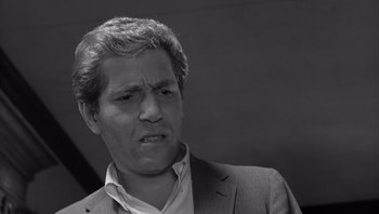 Movie still from “Who's Afraid of Virginia Woolf?” (1966), directed by Mike Nichols – Black and white photograph of a man in a suit; Close Up shot, Low angle