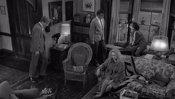 Movie still from “Who's Afraid of Virginia Woolf?” (1966), directed by Mike Nichols – A black and white photo of a group of people in a living room; Wide shot, High angle