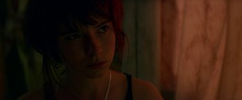 Movie still from “Wild Rose” (2018), directed by Tom Harper – A person wearing a black shirt; Close Up shot, Over the shoulder angle