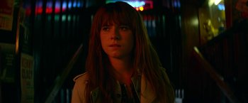 Movie still from “Wild Rose” (2018), directed by Tom Harper – A woman with long red hair is looking at the camera; Close Up shot, Over the shoulder angle