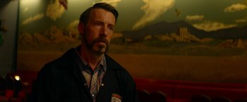 Movie still from “Wild Rose” (2018), directed by Tom Harper – A person wearing a jacket; Medium shot, Low angle