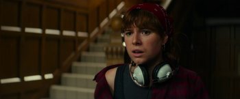 Movie still from “Wild Rose” (2018), directed by Tom Harper – A woman with a red hat and a red scarf is listening to music; Close Up shot, Over the shoulder angle