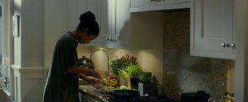Movie still from “Wild Rose” (2018), directed by Tom Harper – A woman is cutting vegetables in the kitchen; Medium shot, Low angle
