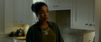 Movie still from “Wild Rose” (2018), directed by Tom Harper – A woman standing in a kitchen wearing a necklace; Close Up shot, Low angle