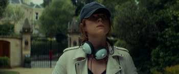 Movie still from “Wild Rose” (2018), directed by Tom Harper – A woman wearing a baseball cap and a white leather jacket; Close Up shot, Low angle