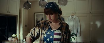 Movie still from “Wild Rose” (2018), directed by Tom Harper – A woman with a bandanna on her head; Medium shot, Over the shoulder angle