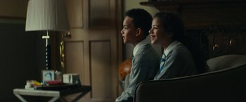 Movie still from “Wild Rose” (2018), directed by Tom Harper – A couple of people sitting next to each other; Medium shot, Over the shoulder angle