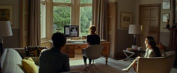 Movie still from “Wild Rose” (2018), directed by Tom Harper – Two people sitting in front of a computer screen; Wide shot, Over the shoulder angle