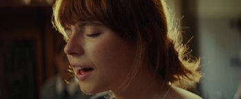 Movie still from “Wild Rose” (2018), directed by Tom Harper – A person with her eyes closed; Extreme Close Up shot, High angle
