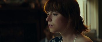Movie still from “Wild Rose” (2018), directed by Tom Harper – A person looking to her left; Close Up shot, Over the shoulder angle