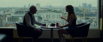 Movie still from “Wild Rose” (2018), directed by Tom Harper – A man and a woman sitting at a table; Medium shot, Over the shoulder angle