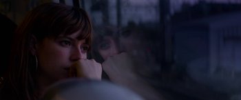 Movie still from “Wild Rose” (2018), directed by Tom Harper – A woman sitting in front of a window with her hand on her face; Close Up shot, Over the shoulder angle