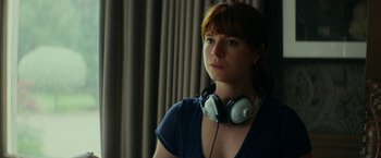 Movie still from “Wild Rose” (2018), directed by Tom Harper – A woman wearing headphones looking at the camera; Close Up shot, Low angle