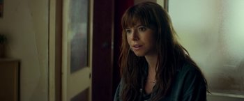 Movie still from “Wild Rose” (2018), directed by Tom Harper – A person with long brown hair; Close Up shot, Over the shoulder angle