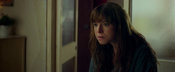 Movie still from “Wild Rose” (2018), directed by Tom Harper – A person with long hair; Close Up shot, Over the shoulder angle