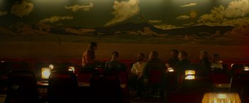 Movie still from “Wild Rose” (2018), directed by Tom Harper – A group of people sitting in a room; Wide shot, Low angle
