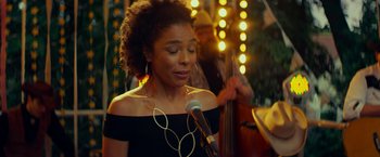 Movie still from “Wild Rose” (2018), directed by Tom Harper – A woman holding a microphone in front of a man playing a guitar; Close Up shot, Over the shoulder angle