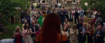 Movie still from “Wild Rose” (2018), directed by Tom Harper – A crowd of people are gathered in a building; Wide shot, Over the shoulder angle