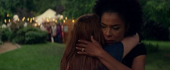 Movie still from “Wild Rose” (2018), directed by Tom Harper – Two women are hugging each other in a field; Close Up shot, Over the shoulder angle