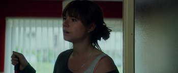Movie still from “Wild Rose” (2018), directed by Tom Harper – A woman with a necklace looking at the camera; Close Up shot, Over the shoulder angle