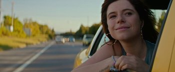 Movie still from “Wild Rose” (2018), directed by Tom Harper – A woman sitting in the driver's seat of a yellow car; Close Up shot, Low angle