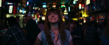 Movie still from “Wild Rose” (2018), directed by Tom Harper – A woman with long brown hair is looking up; Close Up shot, Over the shoulder angle