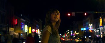 Movie still from “Wild Rose” (2018), directed by Tom Harper – A woman standing on a street at night; Close Up shot, Low angle