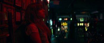 Movie still from “Wild Rose” (2018), directed by Tom Harper – A woman is standing in the dark with her head turned to the side; Close Up shot, Low angle