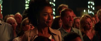 Movie still from “Wild Rose” (2018), directed by Tom Harper – A person wearing a jacket; Close Up shot, Over the shoulder angle