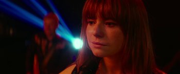 Movie still from “Wild Rose” (2018), directed by Tom Harper – A person with a light in the background; Close Up shot, Over the shoulder angle