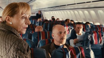 Movie still from “Wild Tales” (2014), directed by Damián Szifron – A man and a woman sitting on a plane; Medium shot, Over the shoulder angle