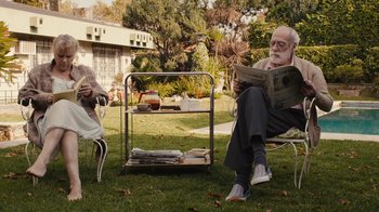 Movie still from “Wild Tales” (2014), directed by Damián Szifron – An older man and woman sitting on lawn chairs reading newspapers; Wide shot, Over the shoulder angle