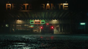 Movie still from “Wild Tales” (2014), directed by Damián Szifron – A car parked in front of a restaurant at night; Extreme Wide shot, Low angle