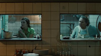 Movie still from “Wild Tales” (2014), directed by Damián Szifron – A woman and a man are sitting at a table; Medium shot, Over the shoulder angle