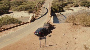 Movie still from “Wild Tales” (2014), directed by Damián Szifron – A car is parked on the side of the road; Extreme Wide shot, High angle
