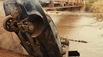 Movie still from “Wild Tales” (2014), directed by Damián Szifron – An overturned car in the middle of a river; Wide shot, High angle
