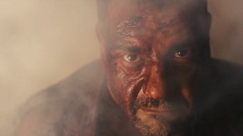 Movie still from “Wild Tales” (2014), directed by Damián Szifron – A person with a face covered in smoke; Close Up shot, Low angle