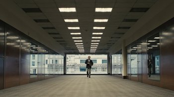 Movie still from “Wild Tales” (2014), directed by Damián Szifron – A man in a suit standing in an empty building; Extreme Wide shot, High angle