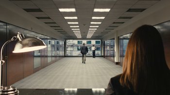 Movie still from “Wild Tales” (2014), directed by Damián Szifron – Three people are walking down a hallway in a building; Extreme Wide shot, High angle