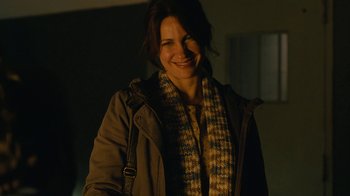 Movie still from “Wild Tales” (2014), directed by Damián Szifron – A woman smiling for the camera while wearing a jacket; Close Up shot, Over the shoulder angle