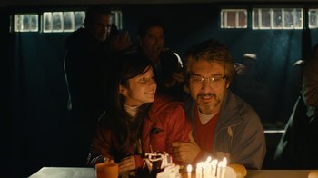 Movie still from “Wild Tales” (2014), directed by Damián Szifron – A man and a woman sitting in front of lit candles; Medium shot, Over the shoulder angle