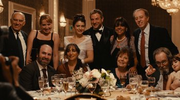 Movie still from “Wild Tales” (2014), directed by Damián Szifron – A group of people posing for a picture at a dinner table; Wide shot, High angle