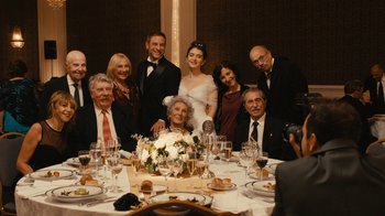 Movie still from “Wild Tales” (2014), directed by Damián Szifron – A group of people sitting around a table with a bride; Wide shot, High angle