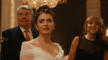 Movie still from “Wild Tales” (2014), directed by Damián Szifron – A woman in a white dress is standing in front of other people; Close Up shot, Over the shoulder angle