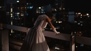 Movie still from “Wild Tales” (2014), directed by Damián Szifron – A woman in a white dress leaning on a rail; Wide shot, Over the shoulder angle