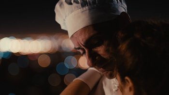 Movie still from “Wild Tales” (2014), directed by Damián Szifron – A man wearing a chef's hat looking down at his face; Close Up shot, Over the shoulder angle