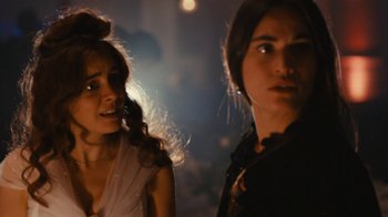 Movie still from “Wild Tales” (2014), directed by Damián Szifron – Two women standing next to each other on a street at night; Close Up shot, Over the shoulder angle