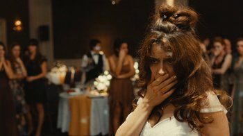 Movie still from “Wild Tales” (2014), directed by Damián Szifron – A woman covering her mouth with her hands; Close Up shot, Over the shoulder angle